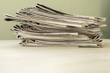 A stack of newspapers. Business news, finance. Latest information. Copy space