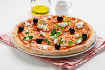 homemade pizza with tomatoes, olives and young cheese.