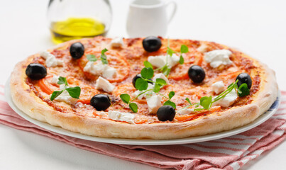 homemade pizza with tomatoes, olives and young cheese.