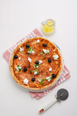 homemade pizza with tomatoes, olives and young cheese.