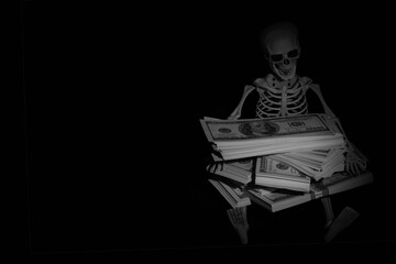 Skeleton skull with US Dollar money as symbol of wealth and greed. Copy space.