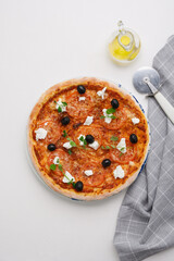 homemade pizza with tomatoes, olives and young cheese.