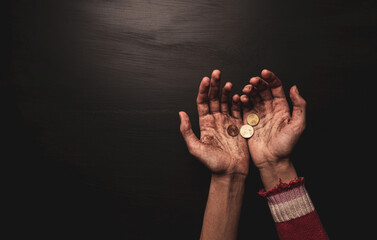 Poverty - kid begging for money. Dirty skinny beggar child’s hands with coins on black. - obrazy, fototapety, plakaty