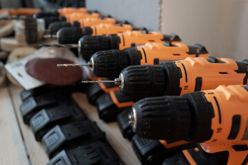 Background image of electric power tools in row at woodworking manufactory, copy space