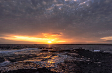 Rough coast at dusk against gloomy sky, Slade, Ireland