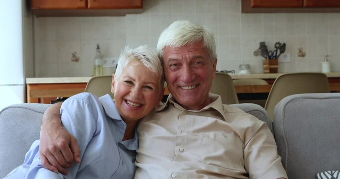 Cheerful mature couple talking to grown up children use video conference app, smile look at camera laughing enjoy distance communication. Older gen and easy comfort usage of modern technology concept