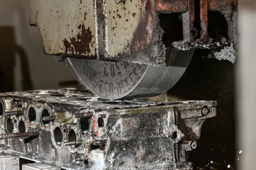 Grinding the surface of the cylinder head on a surface grinder.