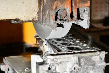Grinding the surface of the cylinder head on a surface grinder.