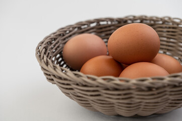 Closeup of fresh brown eggs in Easter basket