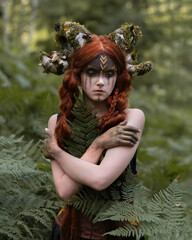 Girl with faun horns covered with moss  - obrazy, fototapety, plakaty