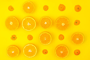 Fresh orange slices on yellow background. Flat lay. Top view.