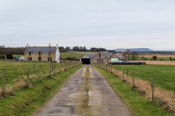 PORTGORDON,MORAY,SCOTLAND - 13 FEBRUARY 2022: This is the road leading to a Farmhouse and its outbuildings in Portgordon, Moray, Scotland on 13 February 2022