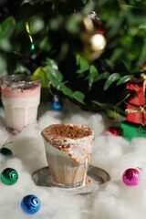 
coffee in front of a pine tree in the snow