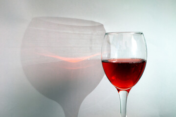 Glass of red wine with shadow