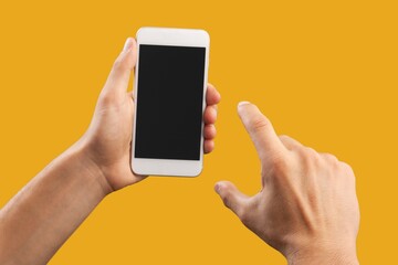 Human hand using smartphone with a blank screen