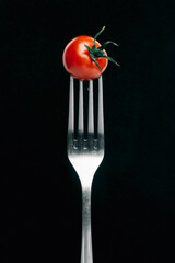 ripe tomato on a fork
