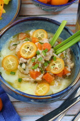 Turkey stew with vegetables, kumquat and mashed potatoes on a blue background