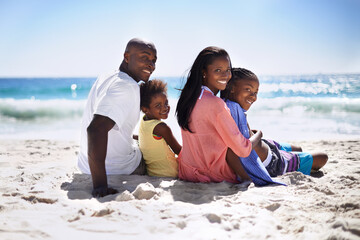 Fototapeta premium Enjoying the ocean. A loving african-american family enjoying a day on the beach together.
