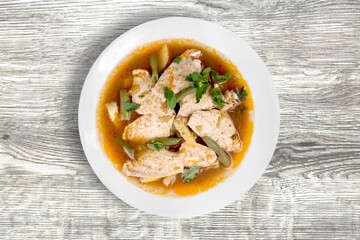 Tasty noodle soup with vegetables in bowl on the desk