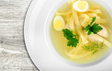 Tasty noodle soup with vegetables in bowl on the desk