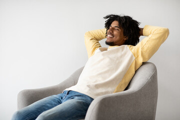 Life Is Good. Young Black Man Relaxing In Armchair At Home, Closeup