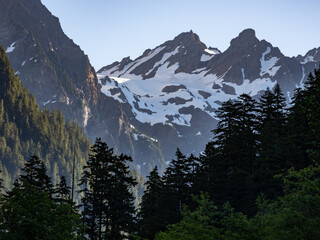 Sunrise on snowcapped peaks, view from within Enchanted Valley in Olympic National Park in Washington.