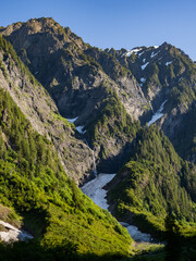 Sunrise on the mountains towering over Enchanted Valley in Olympic National Park, forest covered ridges.
