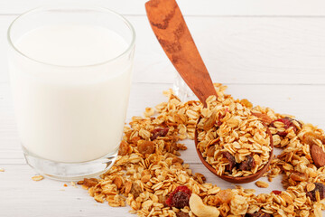 Granola bowl with raisins, nuts and fresh berries. Homemade crunchy granola on grey concrete...