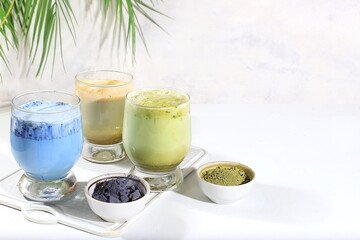 Assortment of colorful Japanese tea latte with milk, green, blue, pink moon milk, golden milk. Fashionable healthy drink has anti-inflammatory properties, promotes weight loss, selective focus