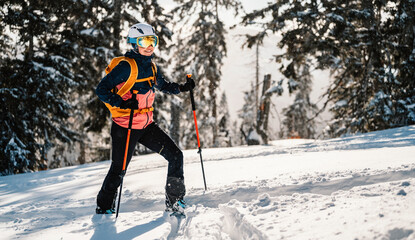 Mountaineer backcountry ski walking ski woman alpinist in the mountains. Ski touring in alpine...