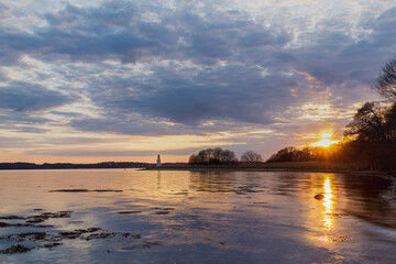 Sunset over the fjord, with lighthouse in the distance