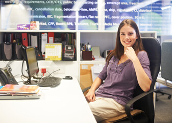 Feeling positive about the day ahead. Cropped portrait of a young businesswoman sitting at her desk.