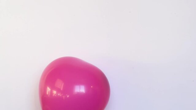 Red balloon in shape of heart inflating and deflating slowly video, symbol of love