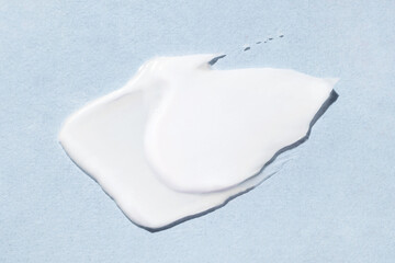 Smear of cream on a blue background.