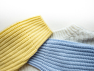 Knitted sweater close-up. Multi-coloured sleeves and neck of a knitted sweater.