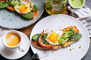 hearty and high-calorie breakfast. delicious and mouth-watering bruschetta with fried eggs and herbs for breakfast with a cup of aromatic coffee.