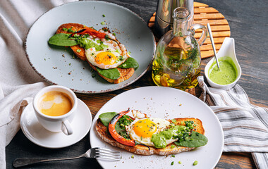hearty and high-calorie breakfast. delicious and mouth-watering bruschetta with fried eggs and herbs for breakfast with a cup of aromatic coffee.