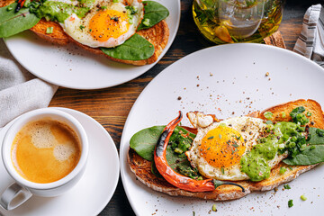 hearty and high-calorie breakfast. delicious and mouth-watering bruschetta with fried eggs and herbs for breakfast with a cup of aromatic coffee.