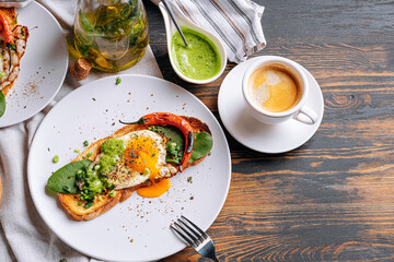 hearty and high-calorie breakfast. delicious and mouth-watering bruschetta with fried eggs and...