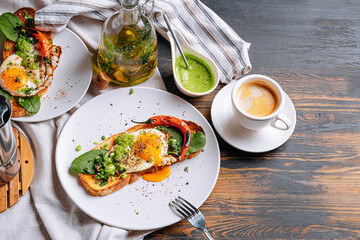 hearty and high-calorie breakfast. delicious and mouth-watering bruschetta with fried eggs and herbs for breakfast with a cup of aromatic coffee.