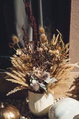 House decor for autumn holidays. Dried flowers boho bouquet. Autumn holiday interior decoration.