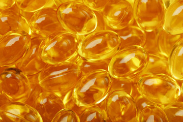 Golden capsules of Vitamin Omega 3 Fish Oil close-up