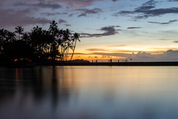 Fototapeta na wymiar Sunset with palms at Waikoloa Beach with colorful skies, Big Island, Hawaii