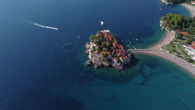 aerial drone view of Sveti Stefan island by the Adriatic coast in Montenegro, on the Mediterranean. Drone view of resort place with beaches and recreation centers