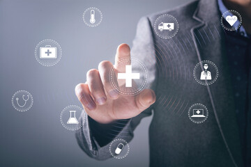 man clicking on medical icons on virtual screen