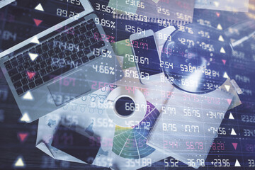 Financial market graph and top view computer on the desktop background. Multi exposure. Investment concept.