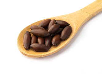 Spoon full of brazilian baru nuts isolated over white background