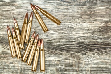 gun bullets on wooden surface background