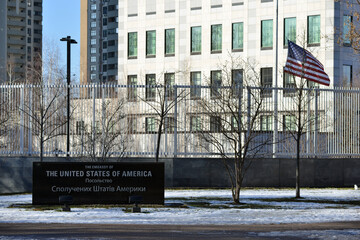 The Embassy of the United States of America in Kyiv. The American flag is lowering from the flagpole.