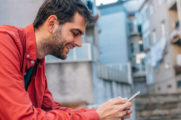 urban style man using mobile or cell phone in the street outdoors